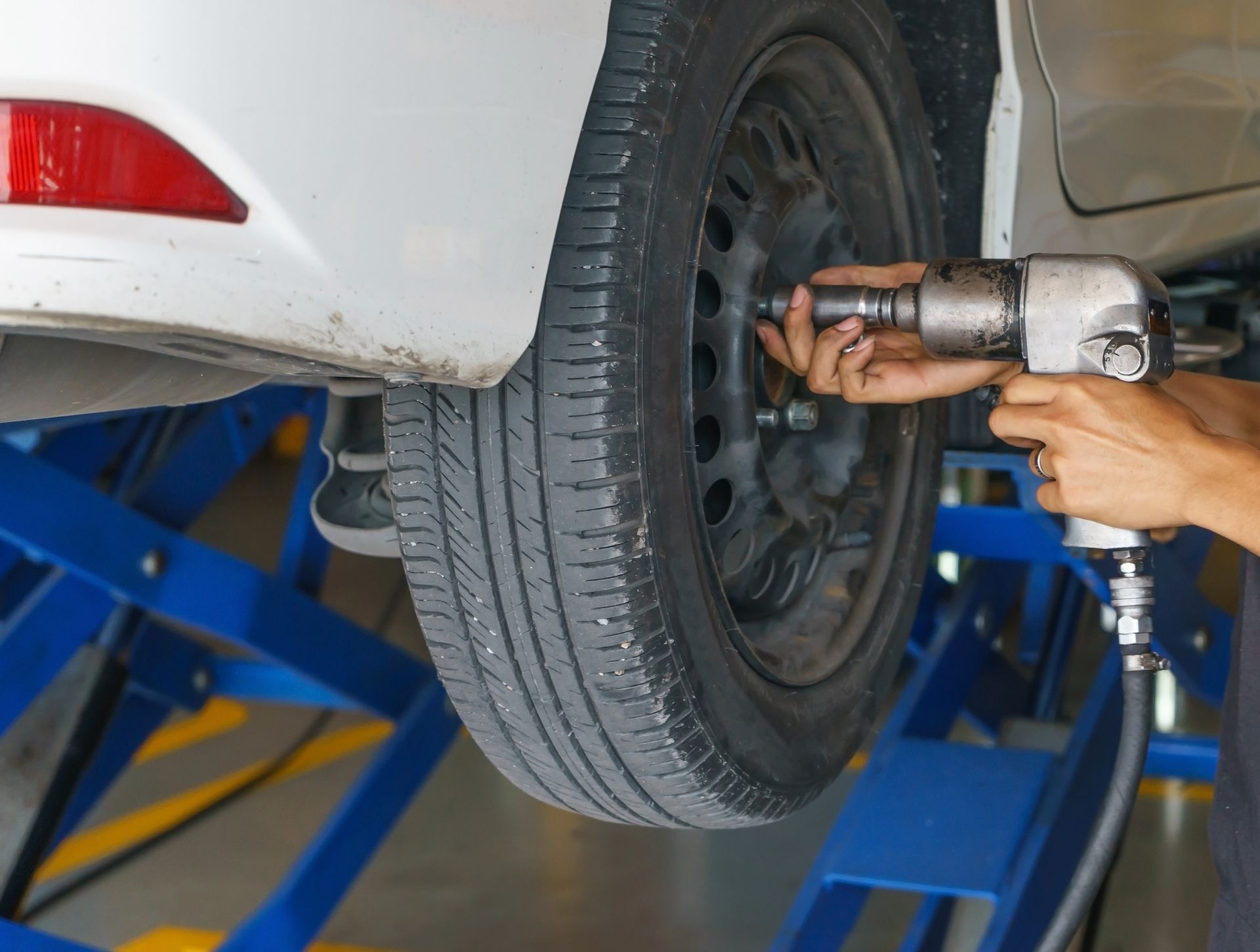 A person doing a tire change for a car