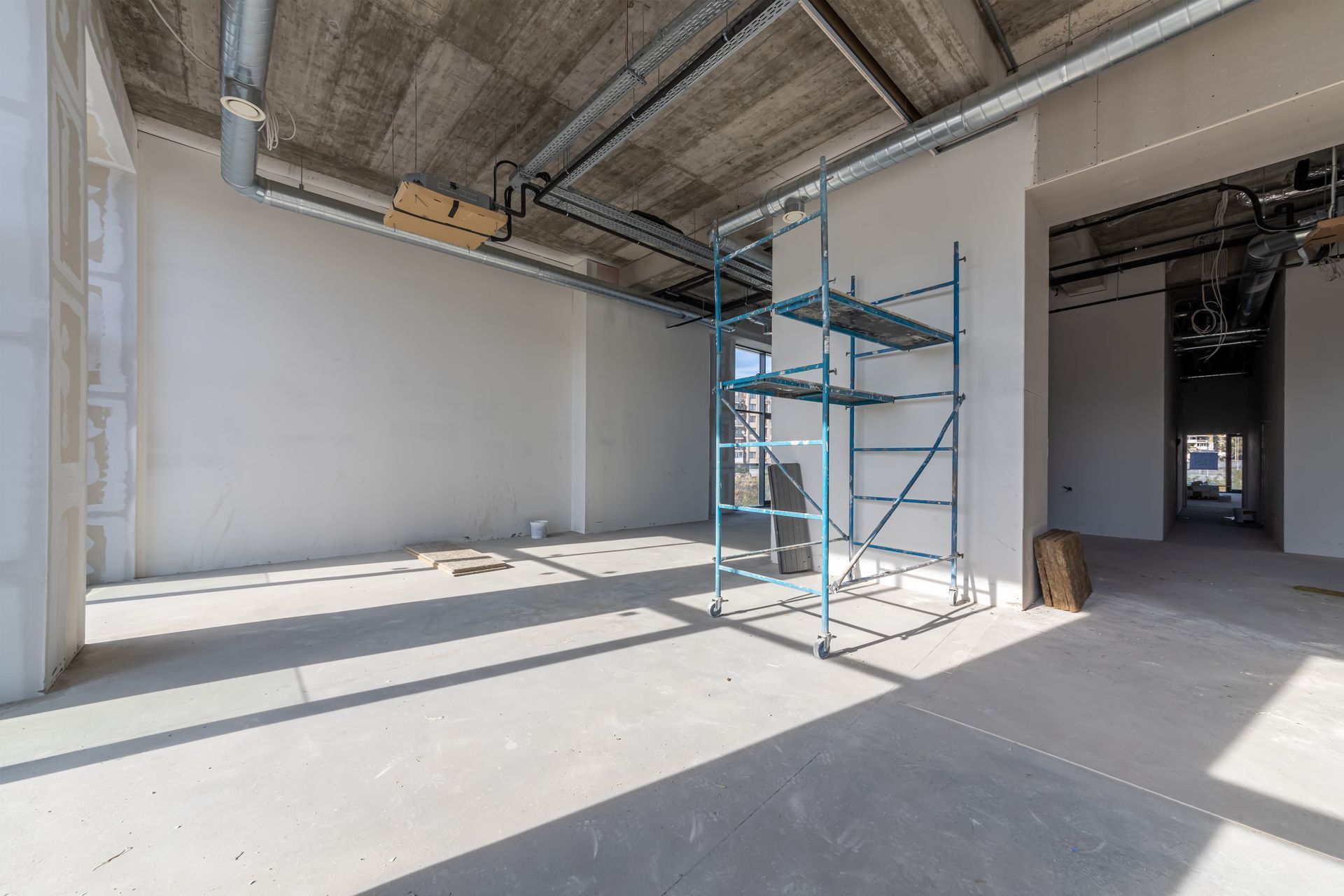 A large empty room with a scaffolding in the middle of it.
