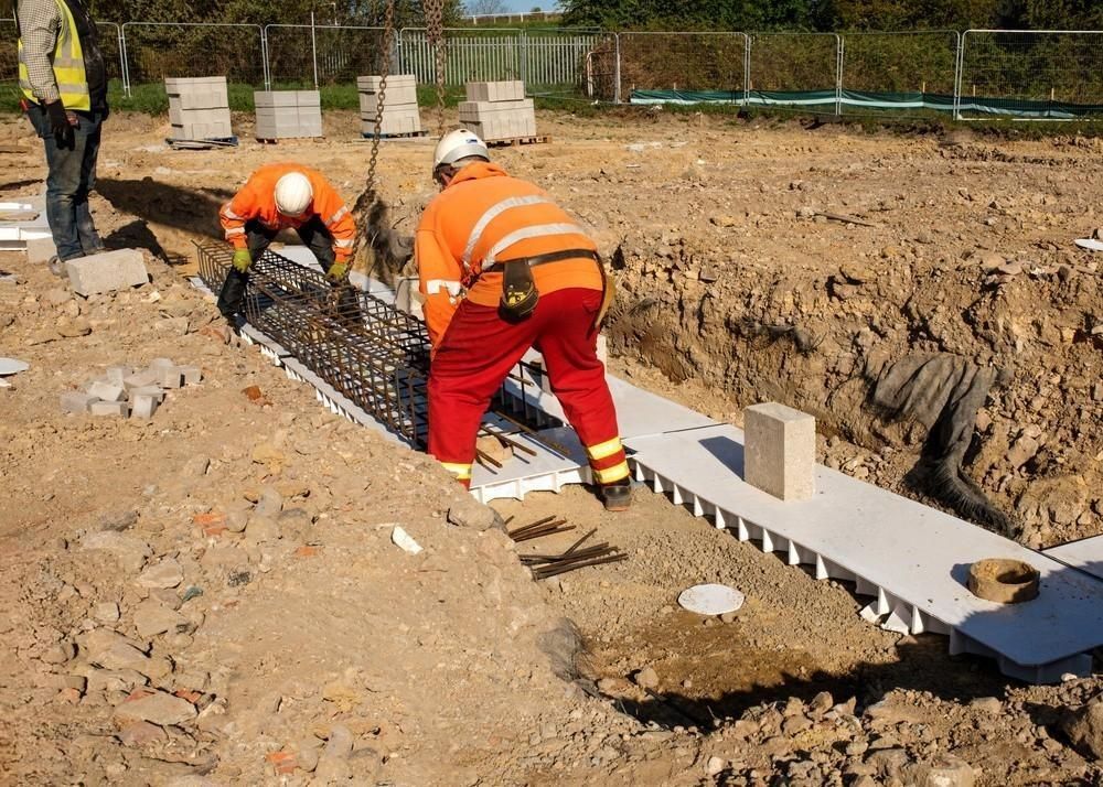 A group of construction workers are working on a construction site.