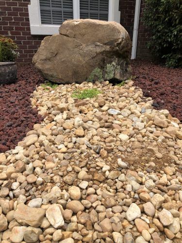 A large white house with a large lawn in front of it.