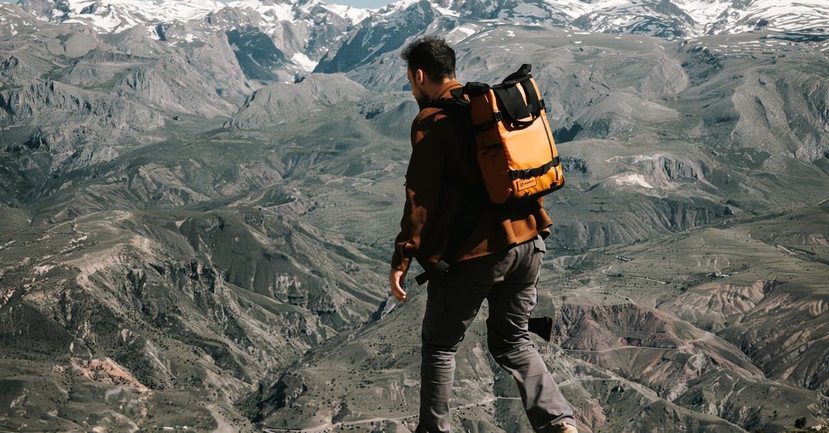 Leader standing on a mountain ridge learning from nature’s terrain