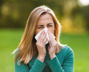 Woman with allergy symptom blowing nose - Allergy treatment in Aberdeen, SD