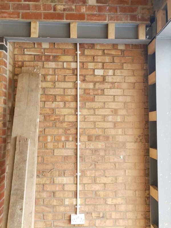 Electrical outlet on a brick wall expertly done Electrician