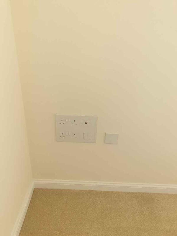 Electrician install wall outlets