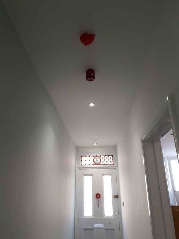 red fire alarm on the ceiling
