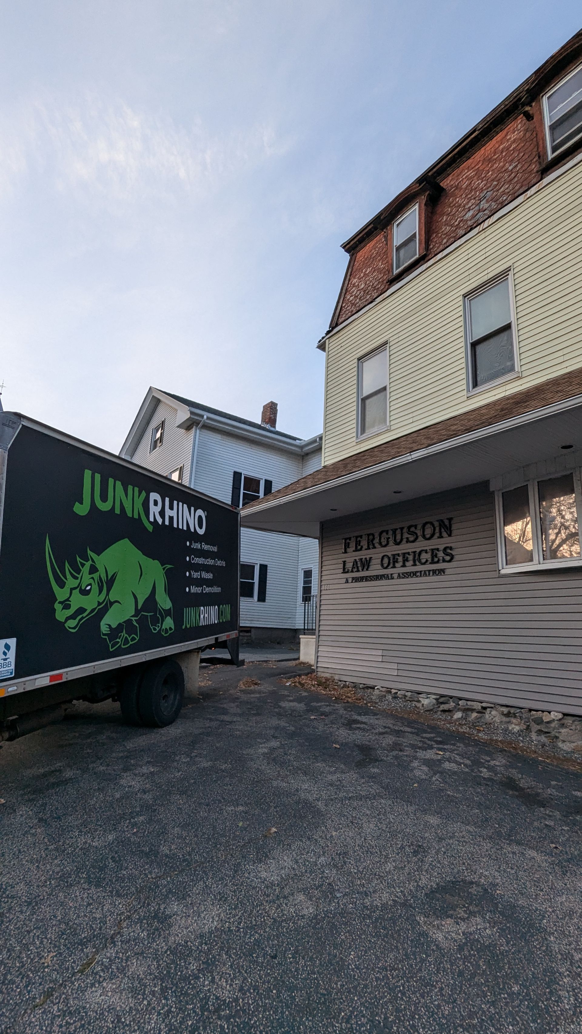 Junk Rhino truck parked next to a building with a 