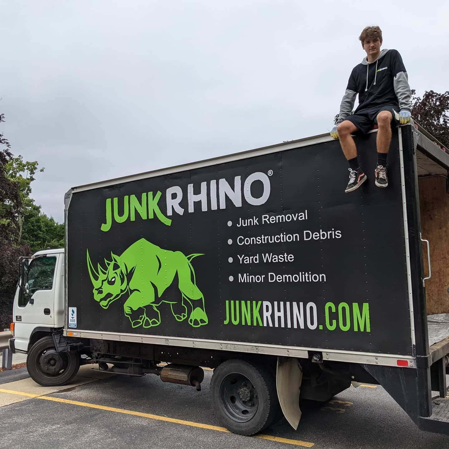 A young person sits atop a black 