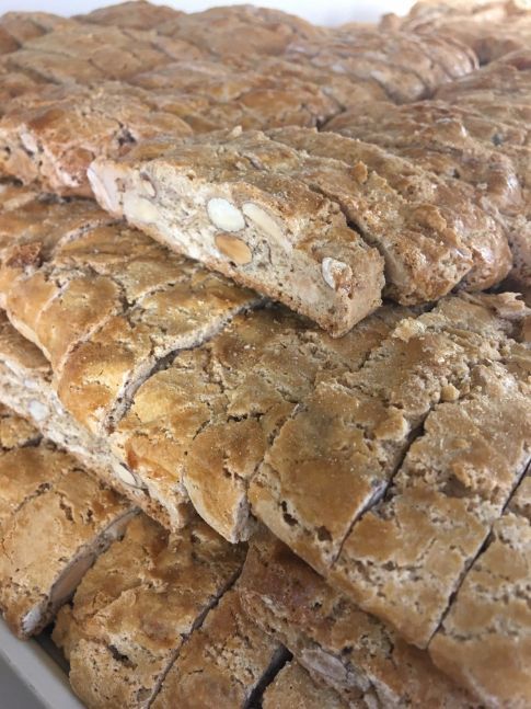 A close up of a tray of bread slices on a table.