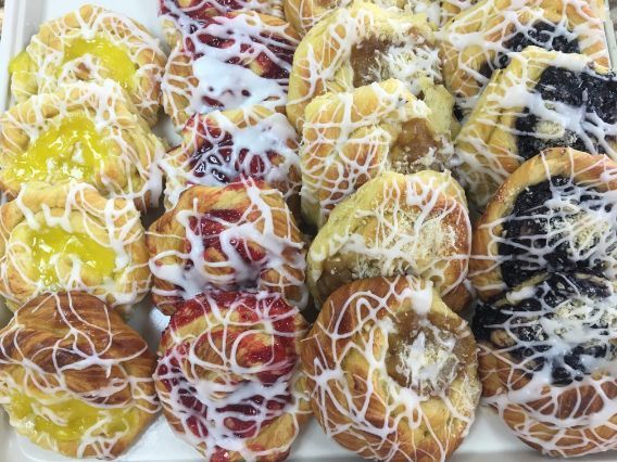 There are many different types of pastries on the tray.