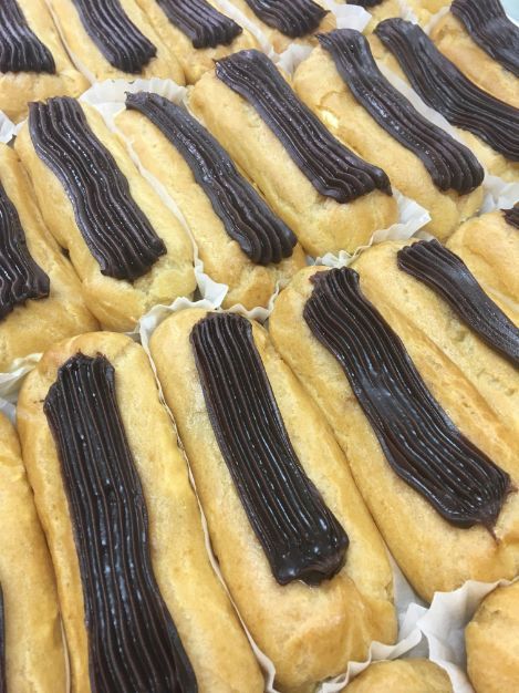 A bunch of cookies with chocolate frosting on them