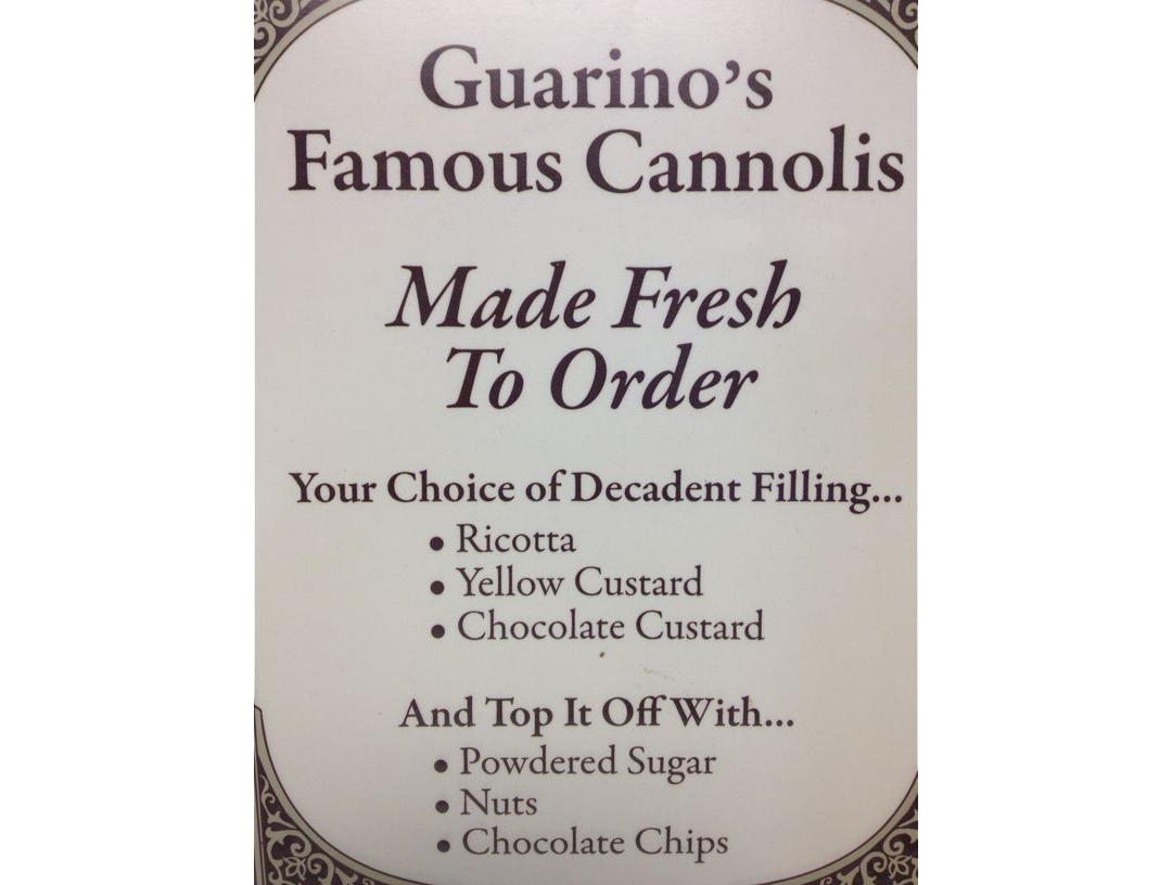 A sign that says guarino 's famous cannolis made fresh to order