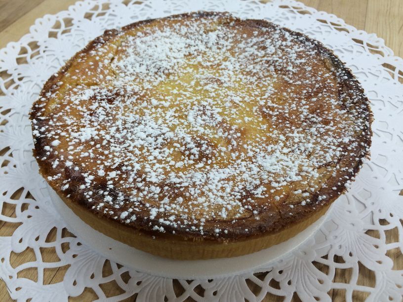 A pie with powdered sugar on top of it