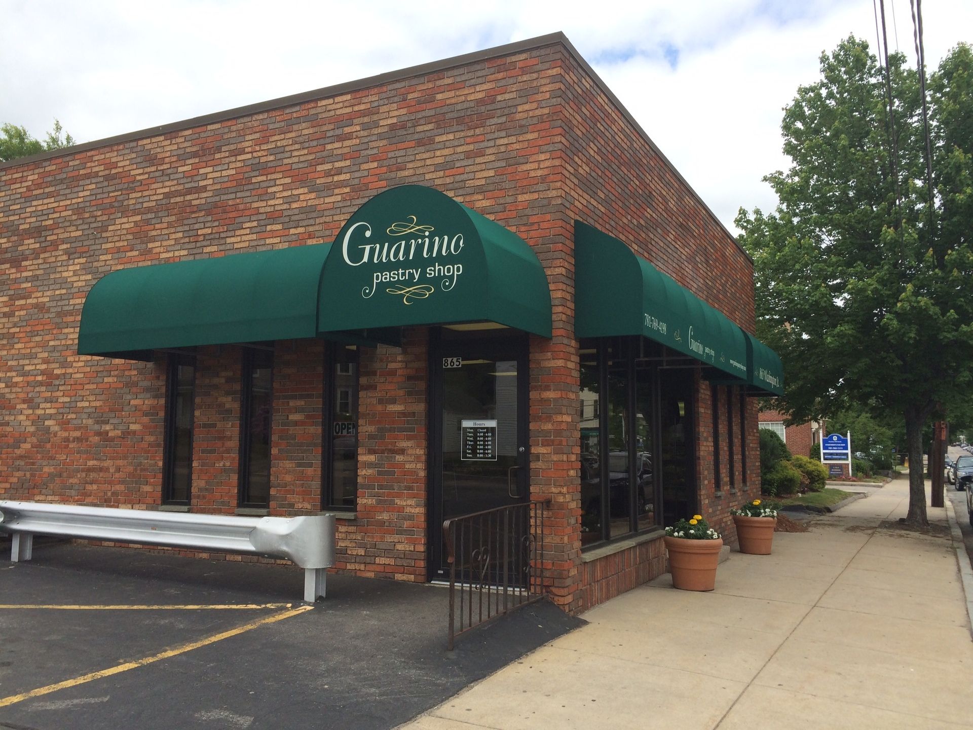 A brick building with a green awning on the side of it