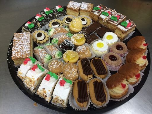 A tray filled with a variety of desserts and pastries