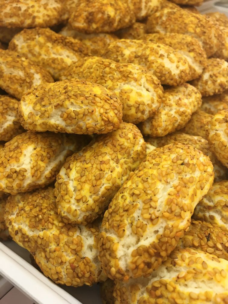 A close up of a tray of sesame seed cookies.