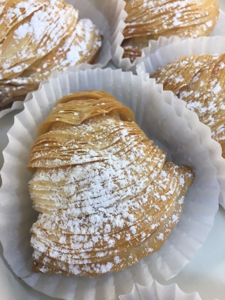 A close up of a pastry with powdered sugar on it