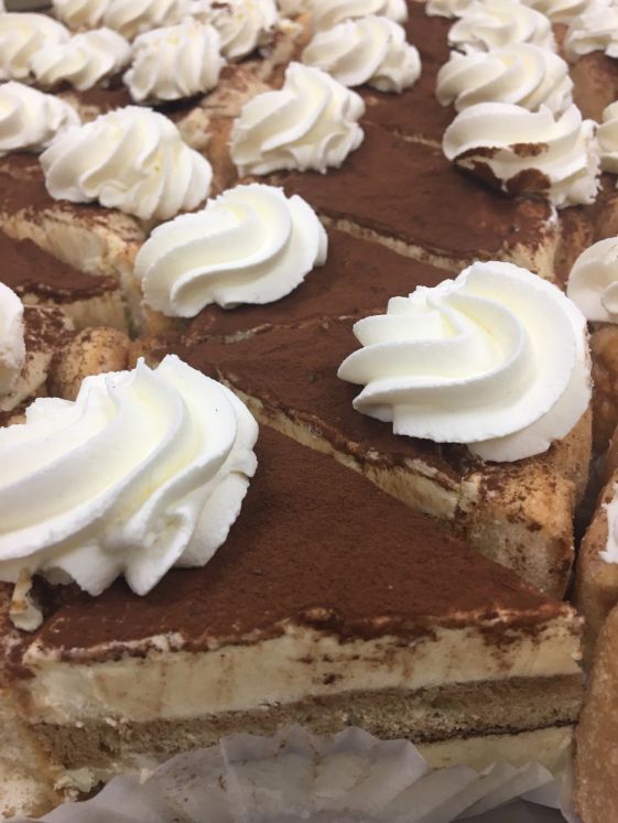 A close up of a cake with whipped cream on top