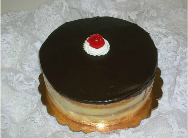 A chocolate cake with a cherry on top of it