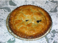 A pie with a face on it is sitting on a table