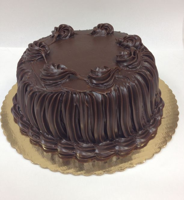 A chocolate cake is sitting on a gold plate