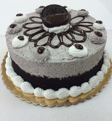 A black and white cake with oreos on top