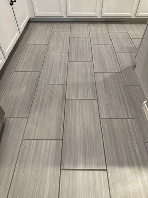 Gray and white rectangular tile flooring in a kitchen.