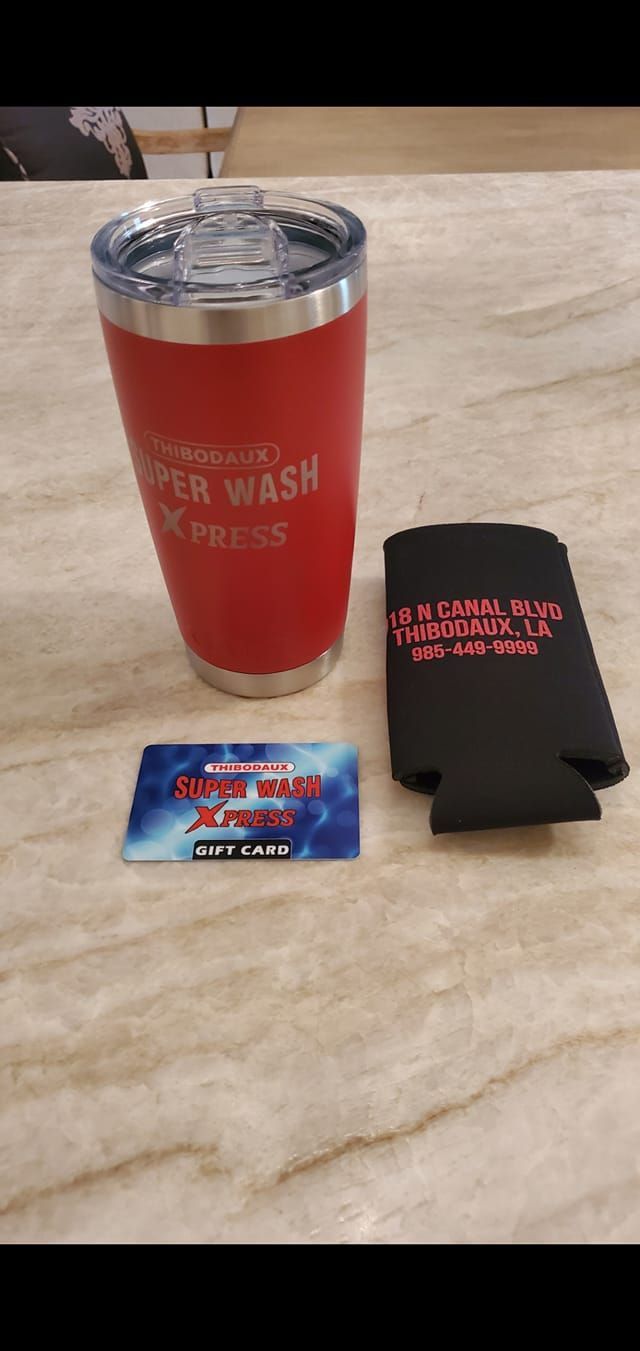 A bright blue Chevrolet Corvette sports car parked in an outdoor lot on a sunny day.