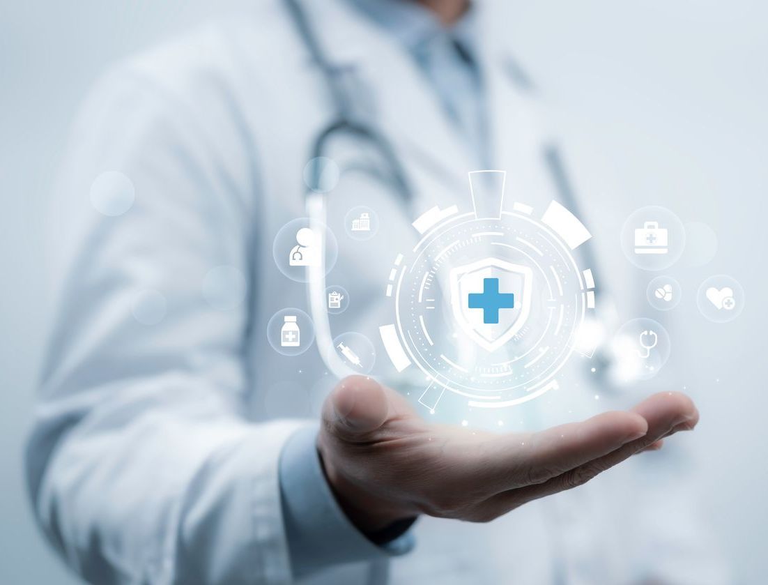 A doctor is holding a virtual cross in his hand.