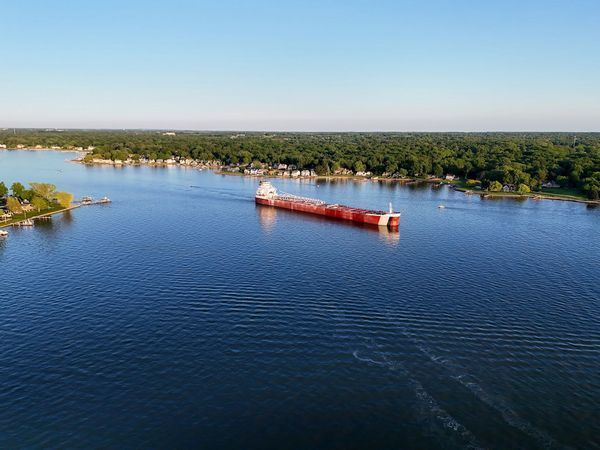 An aerial view of a large ship floating on top of a large body of water.