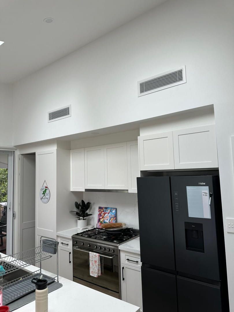A Kitchen With White Cabinets — Cool Heat Air Conditioning in Albion Park, NSW