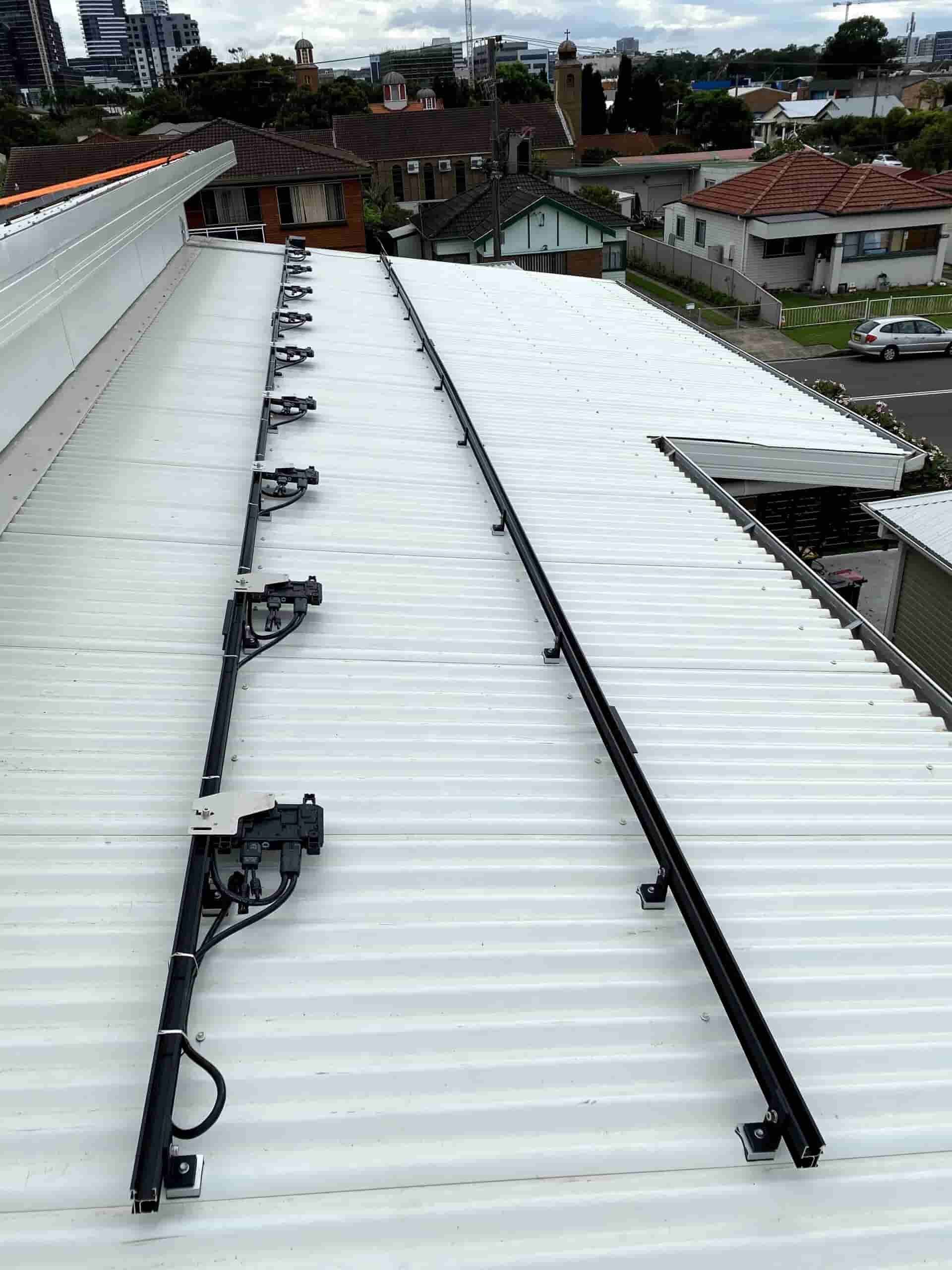 A White Roof With a Row of Solar Panels on It — Cool Heat Air Conditioning in Shellharbour, NSW