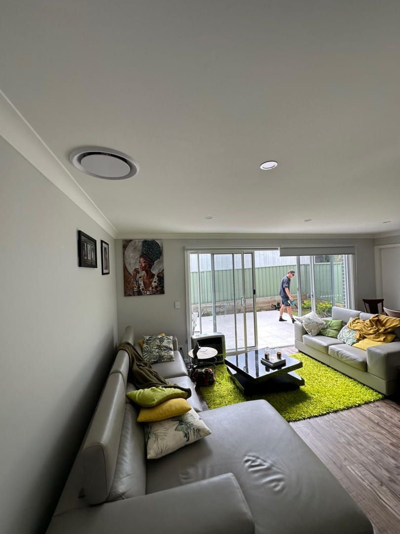 A Living Room With a Couch and a Coffee Table — Cool Heat Air Conditioning in Albion Park, NSW