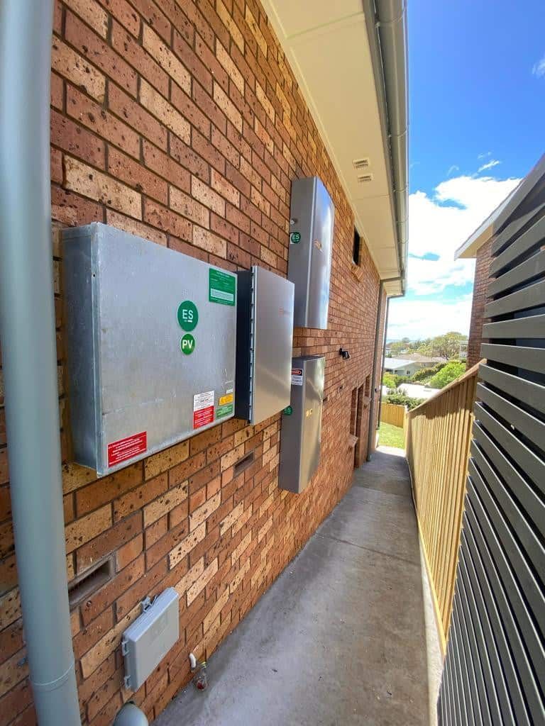 A Brick Wall With a Row of Electrical Boxes on It — Cool Heat Air Conditioning in Albion Park, NSW