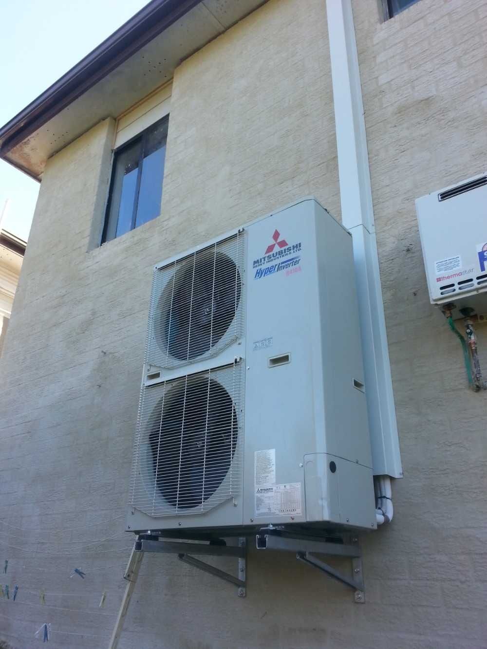 A Mitsubishi Air Conditioner is Mounted on the Side — Cool Heat Air Conditioning in Albion Park, NSW