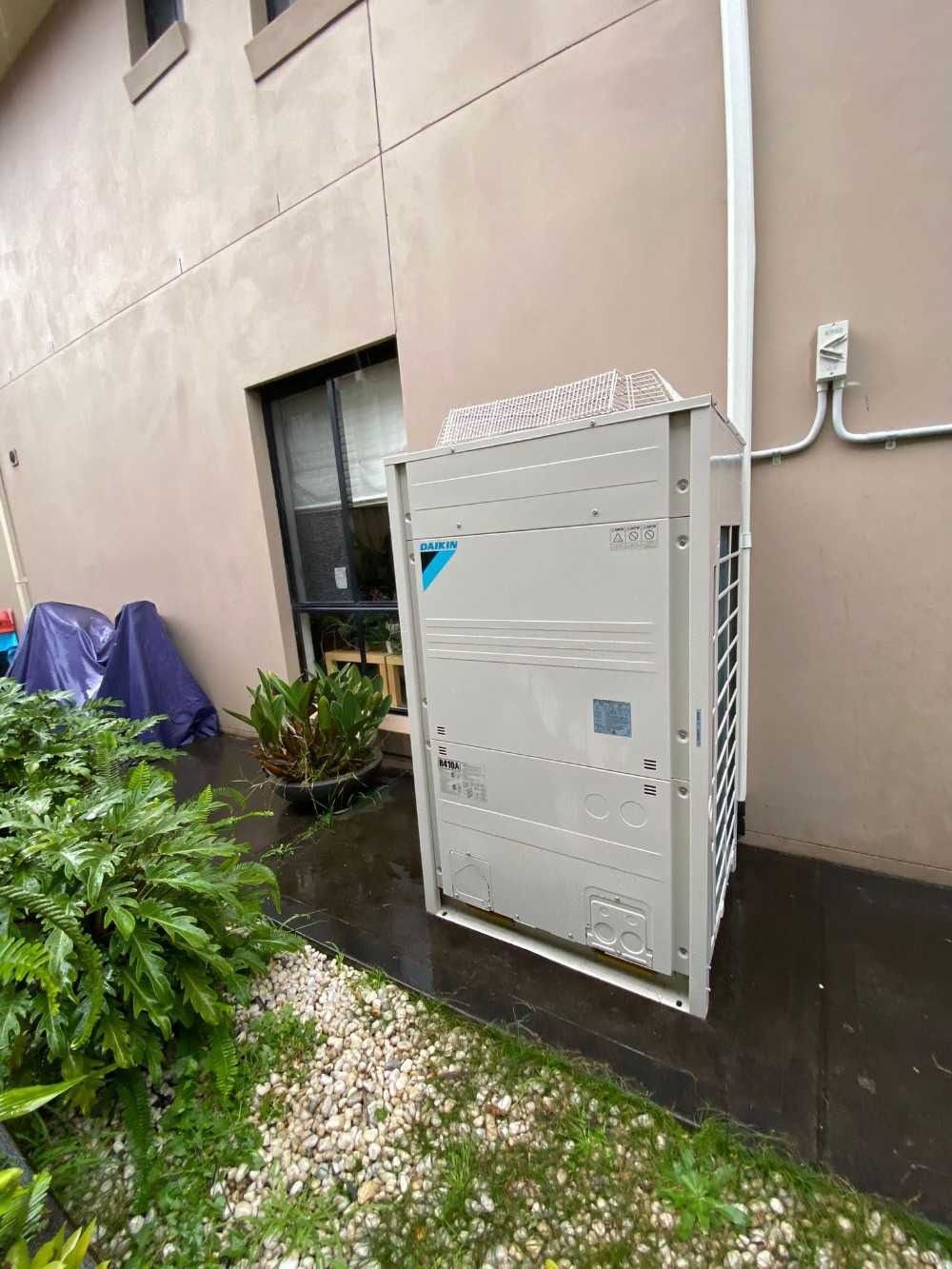A Large White Box is Sitting on the Side of a Building — Cool Heat Air Conditioning in Albion Park, NSW