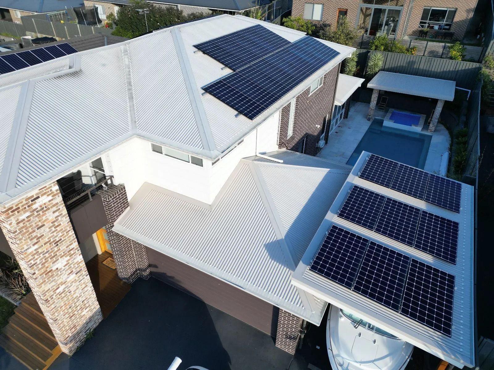 An aerial view of a house with solar panels on the roof— Cool Heat Air Conditioning in Albion Park, NSW
