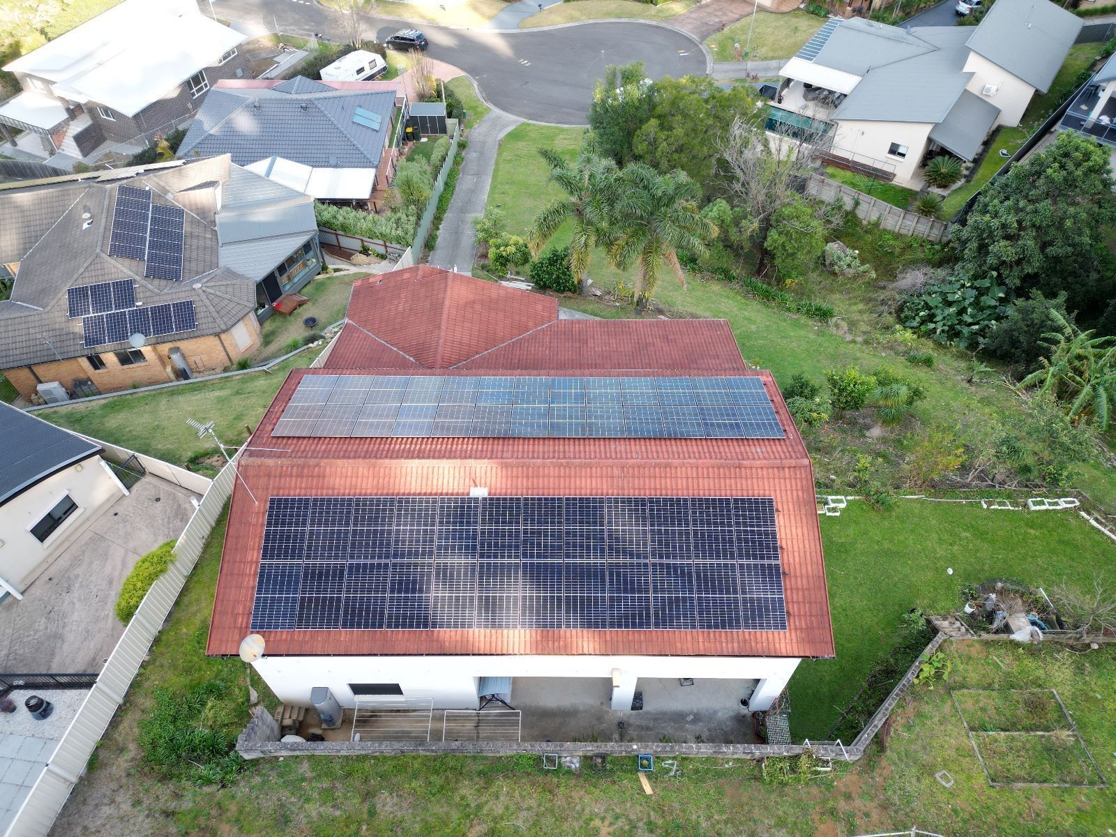 An Aerial View of a House With Solar Panels on the Roof — Cool Heat Air Conditioning in Albion Park, NSW