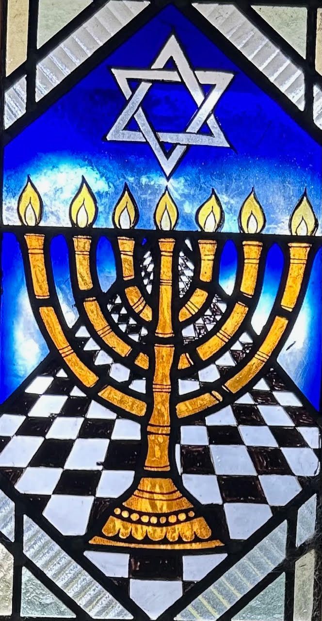 Tan Torah ark curtain with a silver and gold Star of David design.