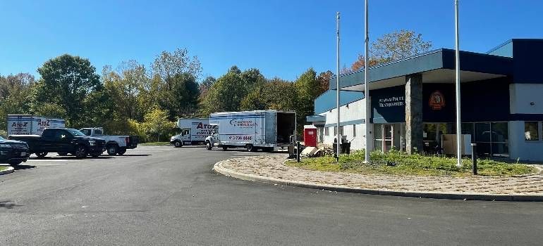 Moving trucks parked outside a town building