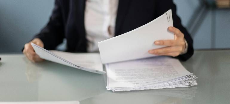 a person reviewing documents before moving to Amherst MA begins