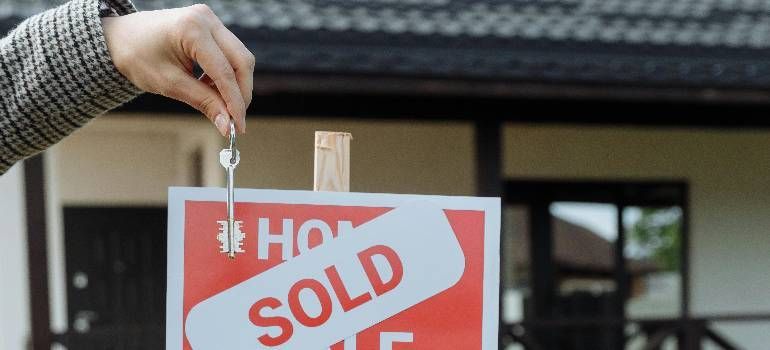 Sold sign in Massachusetts vs Connecticut real estate market comparison
