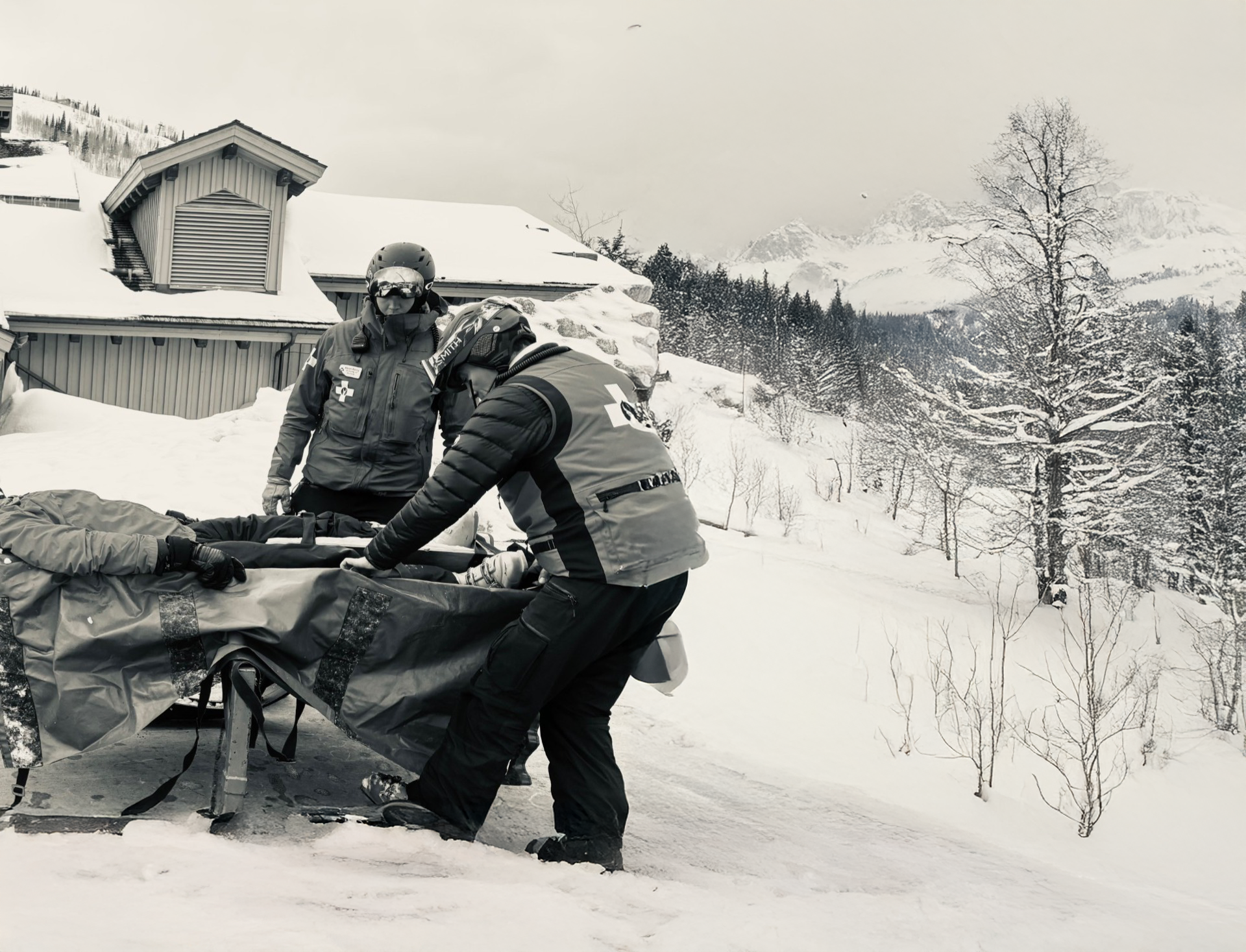 A black and white photo of people in the snow