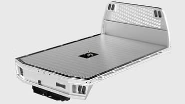 Flatbed truck bed, gray, with a gooseneck hitch and headboard.