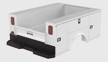 White utility truck bed with black bumper and integrated storage compartments.