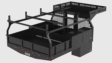 Black truck bed with ladder rack, storage compartments, and tail lights.