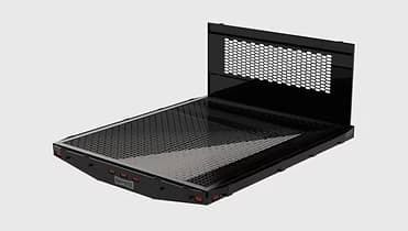 Black flatbed truck bed with a perforated headboard.