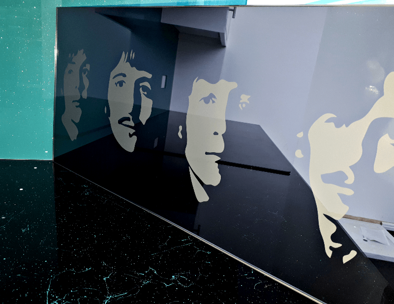 Beatles faces sandblasted into grey mirror
