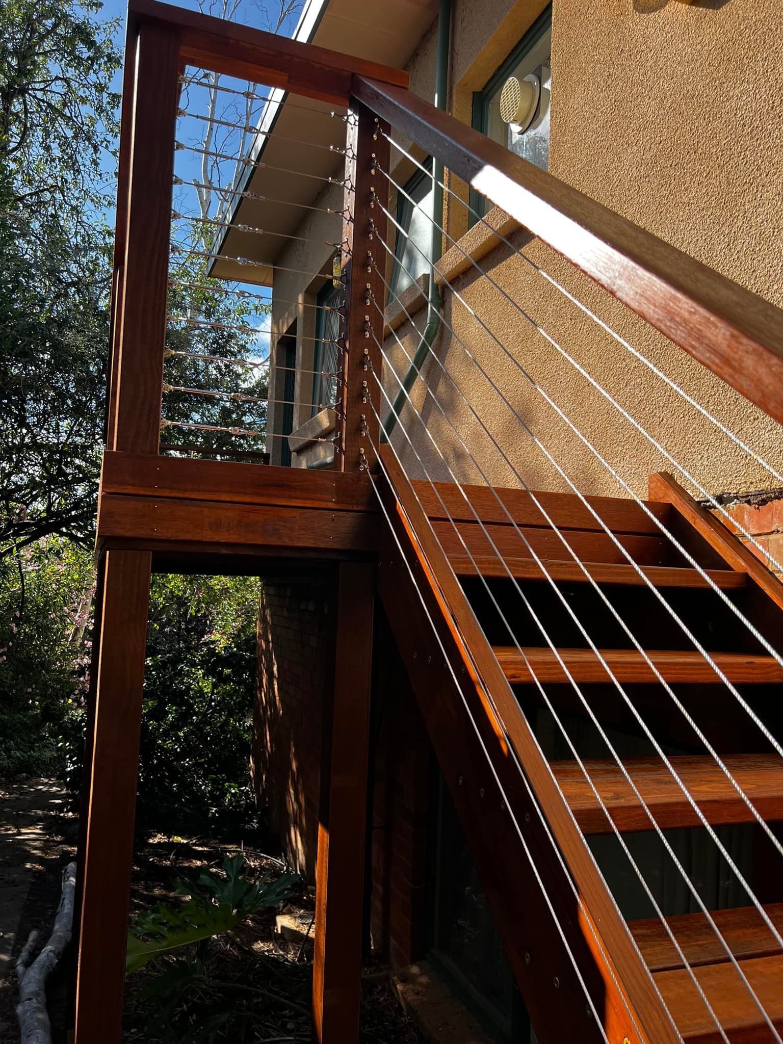 A Wooden Deck with Stairs and A Wire Railing — P & M Maintenance Building Services in Yass River, NSW