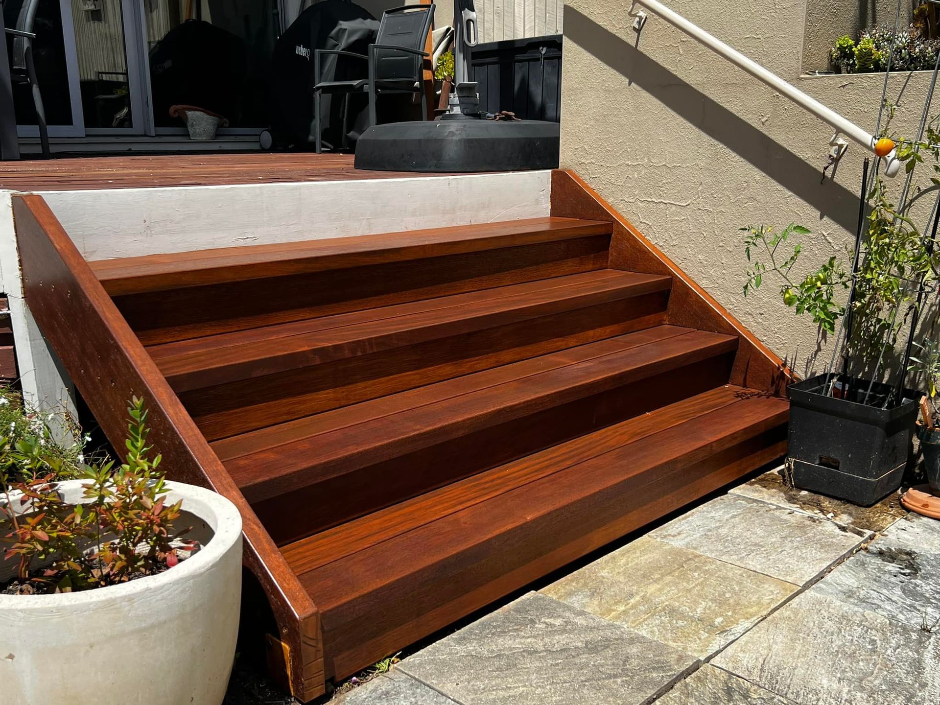 A Set of Wooden Stairs Leading up To a Patio — P & M Maintenance Building Services in Yass River, NSW