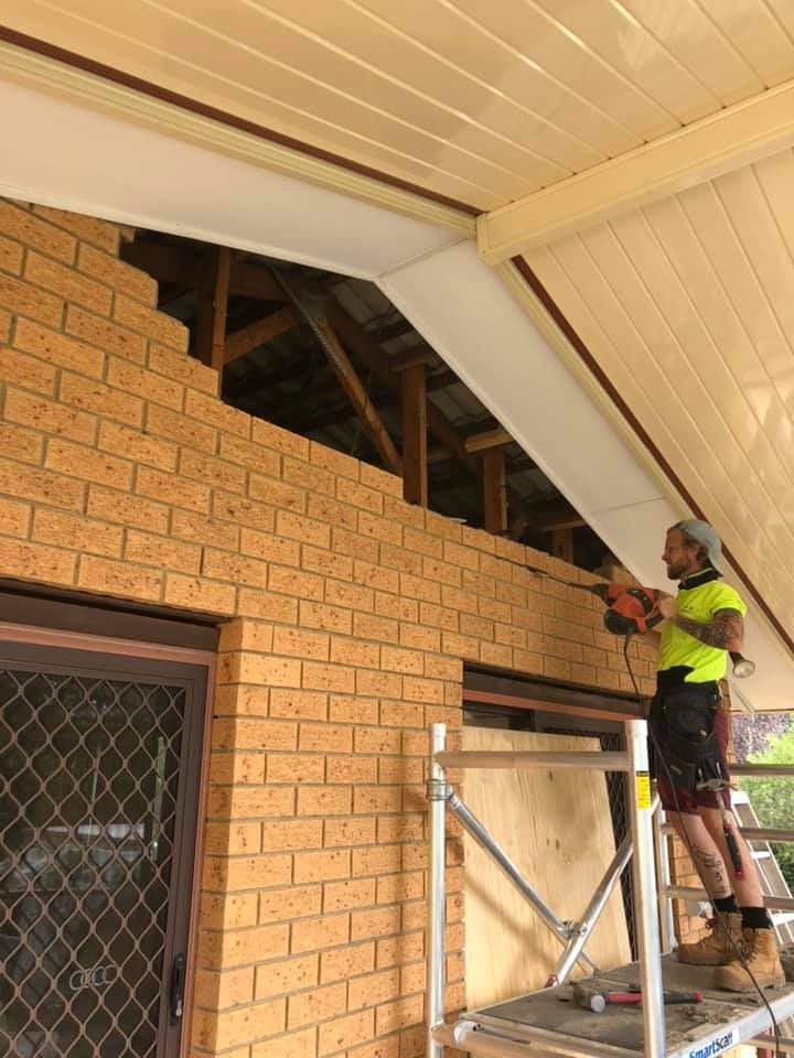 A Kitchen with White Cabinets and A Wooden Counter Top — P & M Maintenance Building Services in Yass River, NSW